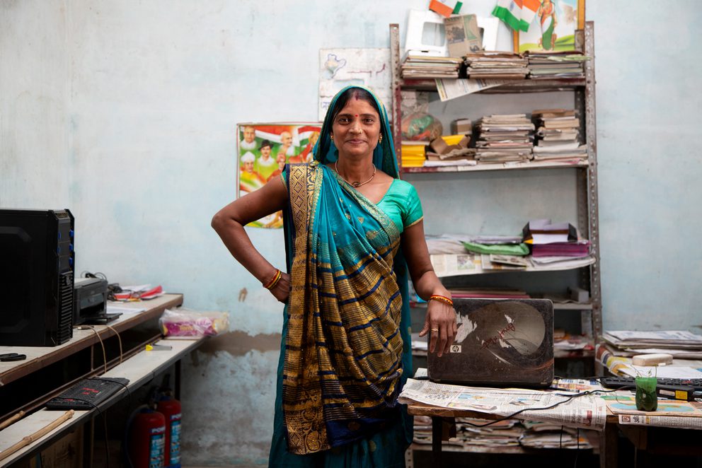 Smiling woman stood in office workshop