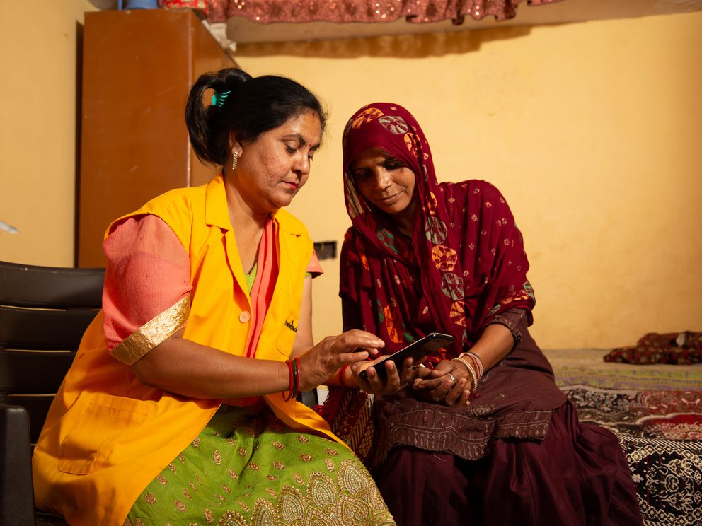 Women demonstrating mobile app to another woman