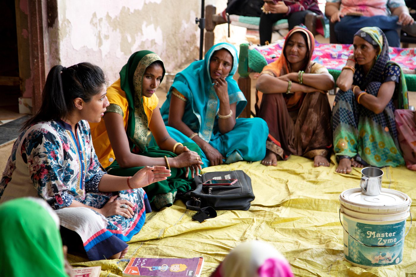 Women sat in a circle listening intently