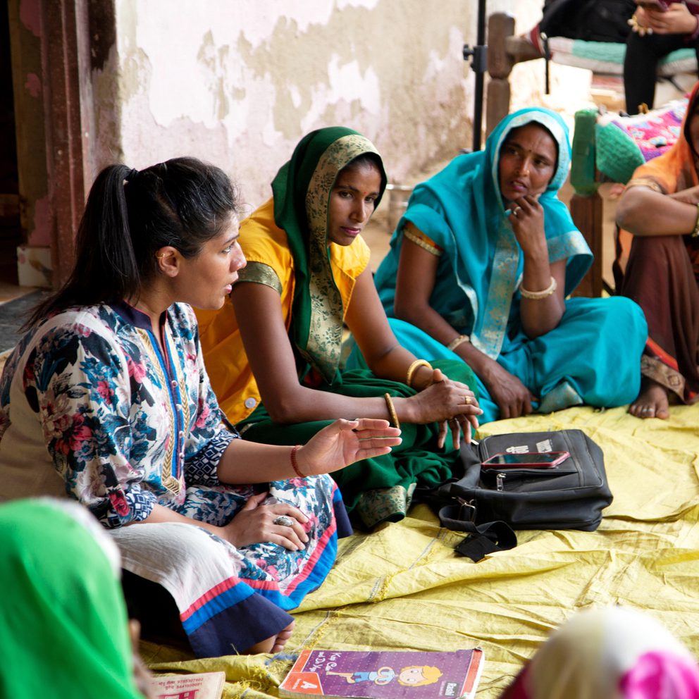 Women sat in a circle listening intently